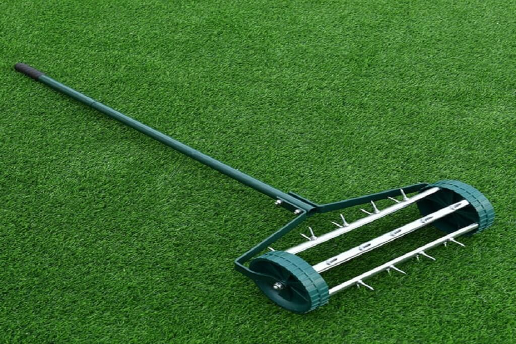 Hand made lawn aerator cutting equal grass.